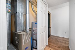 Utility room featuring water heater and heating unit - 