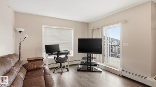 Office area with a baseboard radiator and wood finished floors - 401 636 Mcallister Loop, Edmonton, AB - Indoor Photo Showing Office