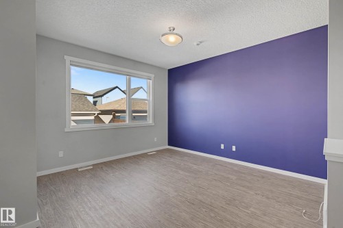 Spare room with light wood-style flooring and a textured ceiling - 2577 Coughlan Road, Edmonton, AB - Indoor Photo Showing Other Room