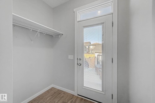 Doorway featuring baseboards and wood finished floors - 2577 Coughlan Road, Edmonton, AB - Indoor