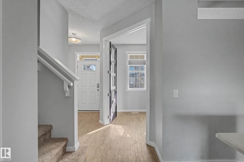 Foyer with a textured ceiling and light wood-type flooring - 2577 Coughlan Road, Edmonton, AB - Indoor Photo Showing Other Room