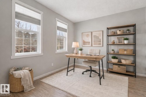 Office space with light wood finished floors and a textured ceiling - 2577 Coughlan Road, Edmonton, AB - Indoor Photo Showing Office