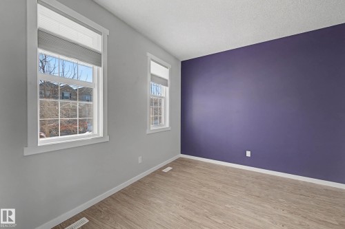 Spare room featuring light wood-type flooring and baseboards - 2577 Coughlan Road, Edmonton, AB - Indoor Photo Showing Other Room