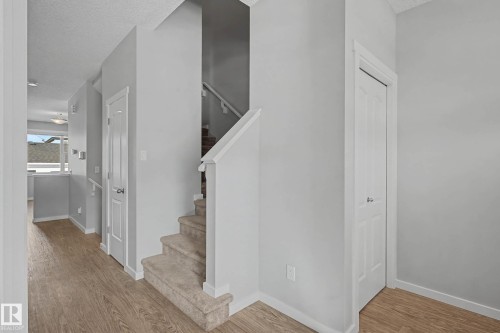 Staircase featuring a textured ceiling and wood finished floors - 2577 Coughlan Road, Edmonton, AB - Indoor Photo Showing Other Room