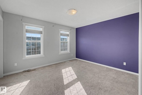 Unfurnished room featuring baseboards and light carpet - 2577 Coughlan Road, Edmonton, AB - Indoor Photo Showing Other Room