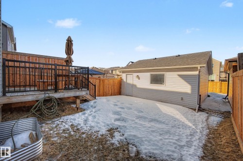 Yard layered in snow with a deck and a fenced backyard - 2577 Coughlan Road, Edmonton, AB - Outdoor With Exterior