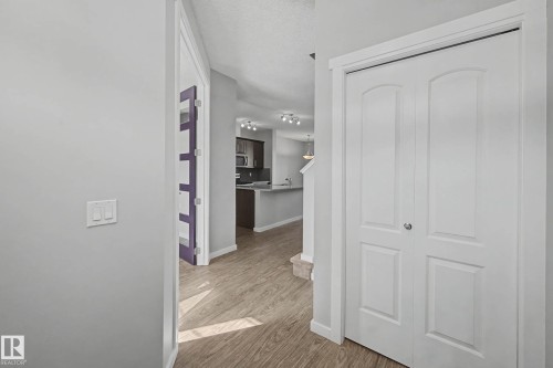 Hallway with light wood-style flooring and a textured ceiling - 2577 Coughlan Road, Edmonton, AB - Indoor Photo Showing Other Room