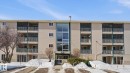 Snow covered building featuring a view of apartment building / complex - 103 1624 48 Street, Edmonton, AB  - Outdoor With Facade 