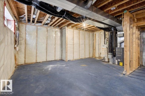 Unfinished below grade area with water heater and heating unit - 150 Acacia Circle, Leduc, AB - Indoor Photo Showing Basement