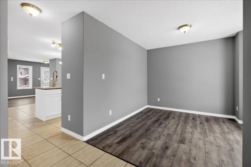 Empty room with a textured ceiling and light wood-style floors - 150 Acacia Circle, Leduc, AB - Indoor Photo Showing Other Room