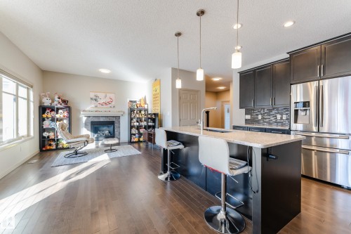 1945 Ainslie Link, Edmonton, AB - Indoor Photo Showing Kitchen With Fireplace With Upgraded Kitchen