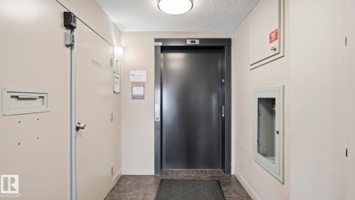 Hallway with elevator and a textured ceiling - 319 274 Mcconachie Drive, Edmonton, AB - Indoor Photo Showing Other Room