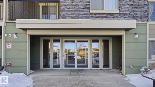 Snow covered property entrance with stone siding - 319 274 Mcconachie Drive, Edmonton, AB - Outdoor