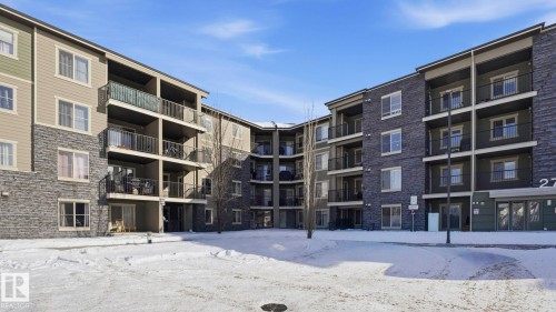 Snow covered building with a view of apartment building / complex - 319 274 Mcconachie Drive, Edmonton, AB - Outdoor With Balcony With Facade