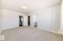 Unfurnished bedroom with a walk in closet and carpet flooring - 2282 Chokecherry Close, Edmonton, AB  - Indoor 
