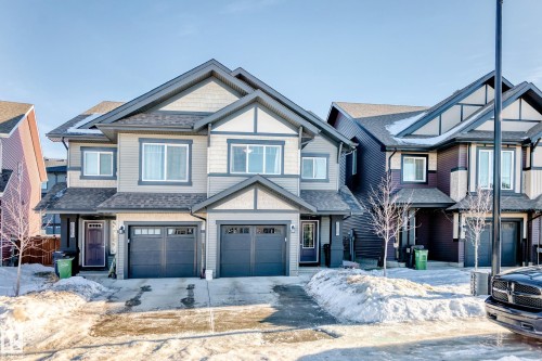 Craftsman inspired home with an attached garage, a shingled roof, and driveway - 2282 Chokecherry Close, Edmonton, AB - Outdoor With Facade