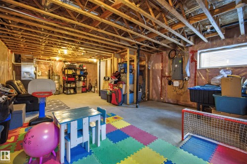 Basement featuring electric panel and water heater - 7074 Cardinal Way, Edmonton, AB - Indoor Photo Showing Basement