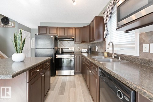97 Keystone Crescent, Leduc, AB - Indoor Photo Showing Kitchen With Double Sink