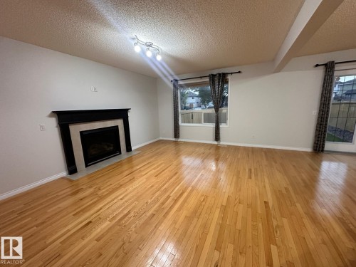 1569 37A Avenue, Edmonton, AB - Indoor Photo Showing Living Room With Fireplace