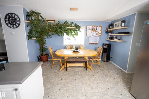 Dining area featuring light wood paneling, a window, and open shelving - 41 Graywood Cove, Stony Plain, AB - Indoor Photo Showing Dining Room
