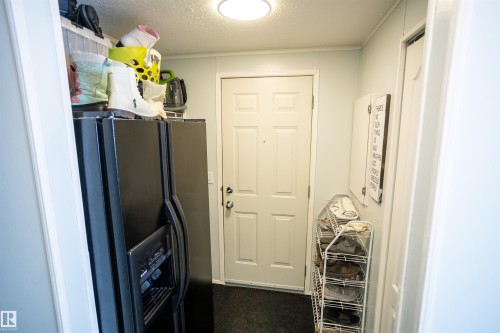 This area features light-colored walls and a door, complemented by a dark floor - 41 Graywood Cove, Stony Plain, AB - Indoor Photo Showing Other Room