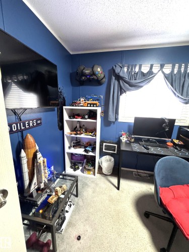First bedroom featuring light carpet and a textured ceiling - 41 Graywood Cove, Stony Plain, AB - Indoor