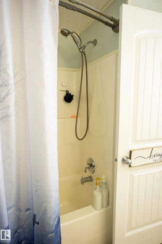 The bathroom features a bathtub with an integrated shower, complete with a chrome shower head and faucet - 41 Graywood Cove, Stony Plain, AB - Indoor Photo Showing Bathroom