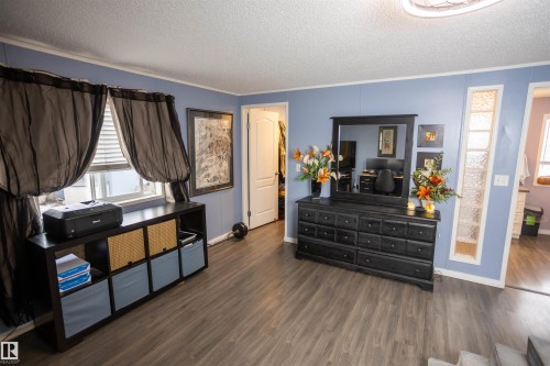 This interior space features durable wood-look flooring, light blue walls, and a white ceiling - 41 Graywood Cove, Stony Plain, AB - Indoor