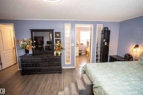 Bedroom featuring wood-style flooring and light blue walls - 41 Graywood Cove, Stony Plain, AB - Indoor Photo Showing Bedroom