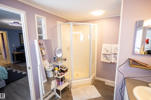 Bathroom featuring a standing shower with a glass enclosure, a vanity with a sink, and a toilet - 41 Graywood Cove, Stony Plain, AB - Indoor
