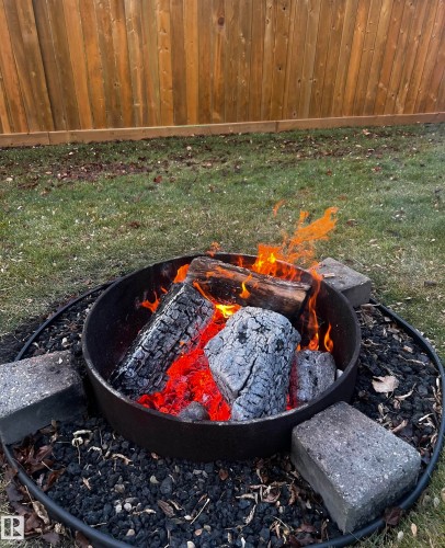 Exterior view of an outdoor fire pit which is hidden under the snow. - 41 Graywood Cove, Stony Plain, AB - 