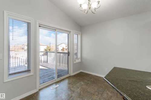 Doorway with a chandelier and baseboards - 20604 48 Avenue, Edmonton, AB - Indoor Photo Showing Other Room
