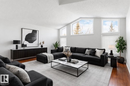 Living room featuring dark wood-type flooring. Virtual staged - 20604 48 Avenue, Edmonton, AB - Indoor Photo Showing Living Room