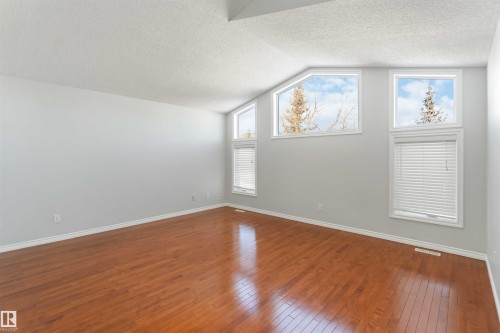 Additional living space with dark wood-type flooring and baseboards - 20604 48 Avenue, Edmonton, AB - Indoor Photo Showing Other Room