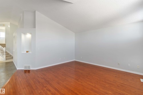 Spare room with hardwood / wood-style flooring and stairs - 20604 48 Avenue, Edmonton, AB - Indoor Photo Showing Other Room