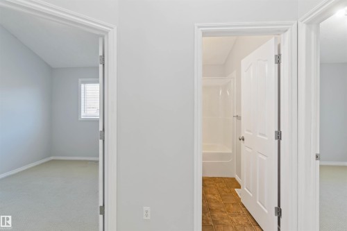 Corridor with light carpet and baseboards - 20604 48 Avenue, Edmonton, AB - Indoor Photo Showing Other Room