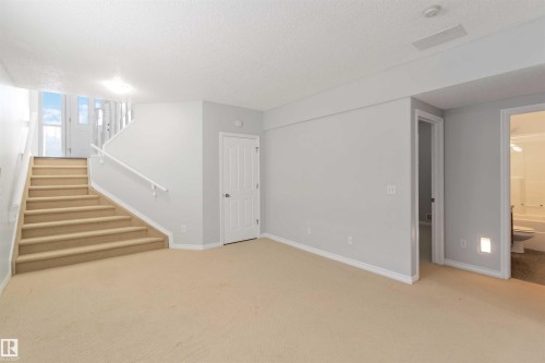 Basement with light colored carpet and a textured ceiling - 20604 48 Avenue, Edmonton, AB - Indoor Photo Showing Other Room