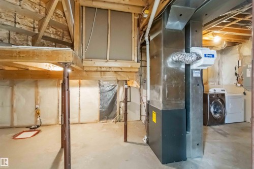 Unfinished basement with heating unit - 20604 48 Avenue, Edmonton, AB - Indoor Photo Showing Laundry Room