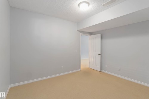 Empty room with light carpet and a textured ceiling - 20604 48 Avenue, Edmonton, AB - Indoor Photo Showing Other Room