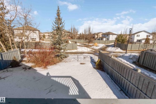 Snowy yard featuring a residential view and a fenced backyard - 20604 48 Avenue, Edmonton, AB - Outdoor