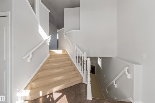 Stairway featuring a high ceiling and tile patterned floors - 20604 48 Avenue, Edmonton, AB - Indoor Photo Showing Other Room