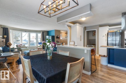 Dining space with a textured ceiling, light wood-type flooring, and hanging lights - 14 Lester Crescent, St. Albert, AB - Indoor Photo Showing Dining Room