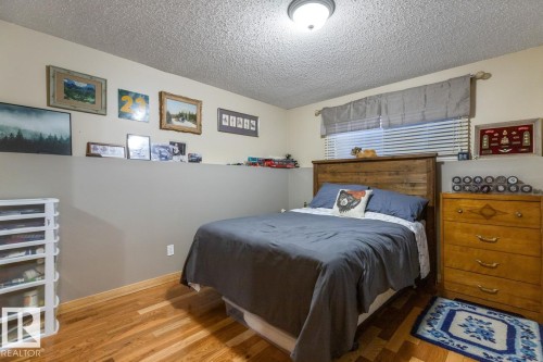 Bedroom featuring a textured ceiling and light wood-style flooring - 14 Lester Crescent, St. Albert, AB - Indoor Photo Showing Bedroom