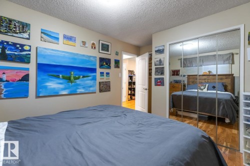 Bedroom featuring a textured ceiling, wood finished floors, and a closet - 14 Lester Crescent, St. Albert, AB - Indoor Photo Showing Bedroom