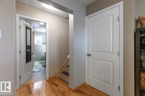 Hallway with light wood-style flooring and a textured ceiling - 14 Lester Crescent, St. Albert, AB - Indoor Photo Showing Other Room