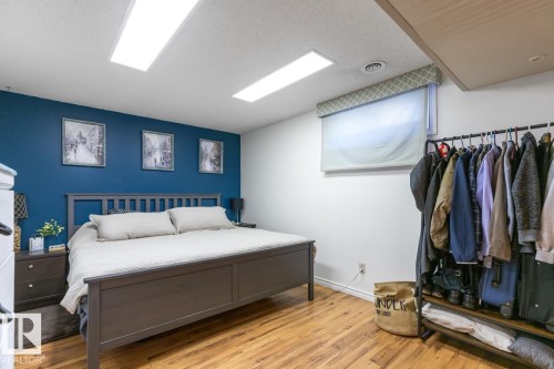 Bedroom with light wood-style floors and a textured ceiling - 14 Lester Crescent, St. Albert, AB - Indoor Photo Showing Bedroom