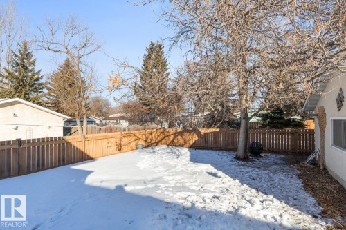 Yard layered in snow with a fenced backyard - 14 Lester Crescent, St. Albert, AB - Outdoor