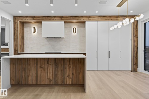 Walk in closet with light wood finished floors - 8765 Mayday Lane, Edmonton, AB - Indoor Photo Showing Other Room