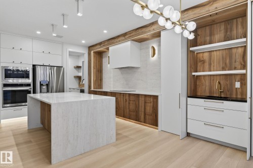 Dual tone kitchen featuring open shelves, modern cabinets, stainless steel appliances, light stone countertops, and dual tone cabinets - 8765 Mayday Lane, Edmonton, AB - Indoor Photo Showing Kitchen With Upgraded Kitchen