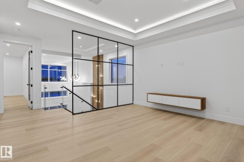Spare room with light wood-type flooring, a tray ceiling, and recessed lighting - 8765 Mayday Lane, Edmonton, AB - Indoor Photo Showing Other Room